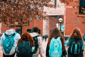 Students with backpacks walking on college campus